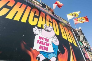 John Byrne/Tribune Steve Weber places a flag on Chicago BBQ’s display in preparation for the 27th annual Best in the West Nugget Rib Cook-Off, which runs from Wednesday through Monday. See a schedule of Rib Cook-Off events on page 6.