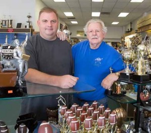 John Byrne/Tribune Lee Langhan, left, and his father Bob inside the family’s trophy shop, which has been in Sparks for more than 25 years.