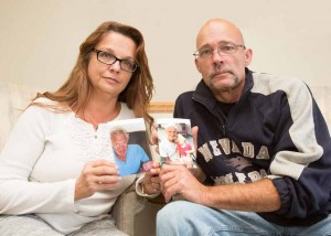 John Byrne/Tribune Elizabeth Estes, left, and her brother, Don Duckett, pose with photos of their dad, Donald Duckett, who died after he was struck by a car while crossing Prater Way in his motorized wheelchair.