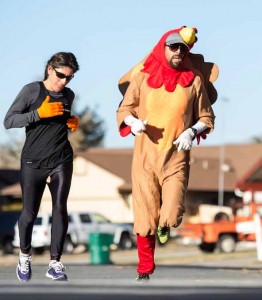 John Byrne/Tribune Ryan Hess, the Reed High School cross country coach (right), displays the Thanksgiving spirit while running Saturday in Mendive Middle School’s inaugural Turkey Trot. The fundraising event featured a 1.5K fun run and a 5K run, with proceeds from registration fees going to the school’s PTA to support academic programs.