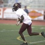 Sparks High quarterback Tyler Green looks for running room during Friday’s game at 4A Douglas.