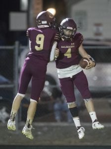 Cole Meacham celebrates with Railroader quarterback Tyler Green after a touchdown in Friday night’s win over Dayton.