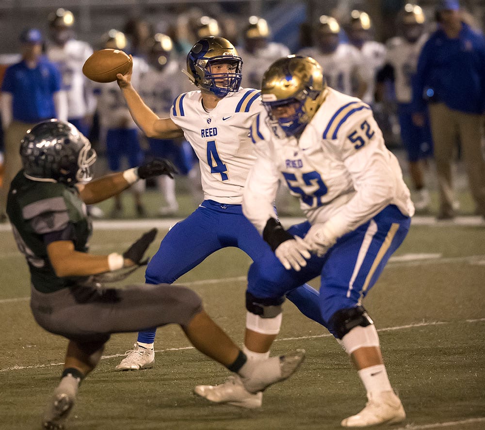 John Byrne/Tribune | Reed’s Baylor Horning drops back to pass while Jeston Vaulet throws a block in the Raiders 52-6 loss to Damonte Ranch Friday in the Northern Regional playoffs. The loss ended Reed’s season.