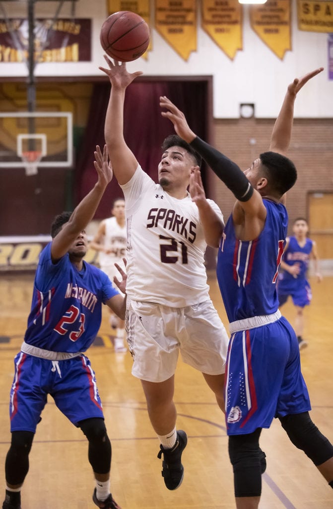 John Byrne/Tribune Sparks senior forward Francisco Guardado attempts a shot during the Railroaders 59-26 win over McDermitt last Wednesday at home in the Rail City Classic tournament. It was the second victory of the year for the Sparks boys after finishing winless last season.